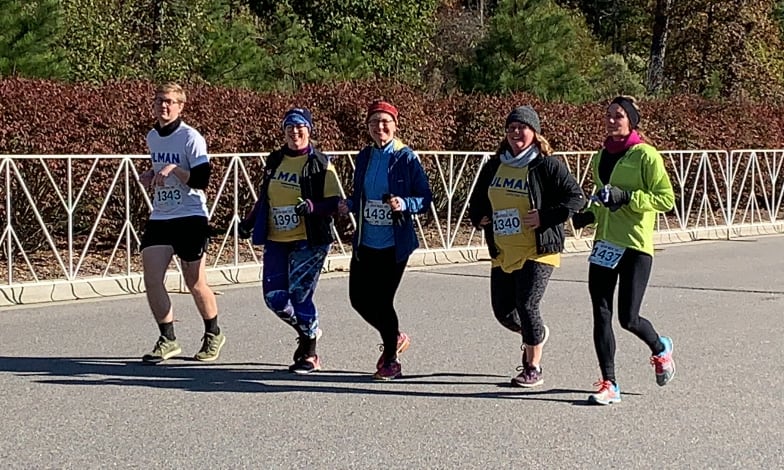 Cancer to 5K survivors and volunteers and coaches running the goal race and nearing the finish line in Durham, North Carolina!